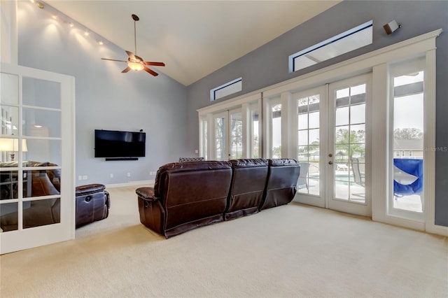 living area with french doors, carpet flooring, ceiling fan, high vaulted ceiling, and baseboards