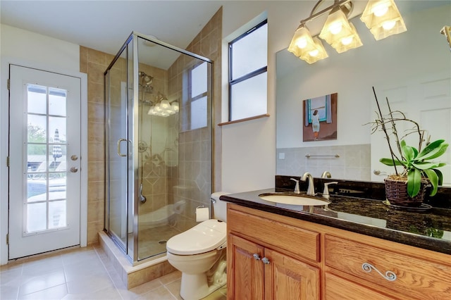 full bath featuring a stall shower, a healthy amount of sunlight, and vanity