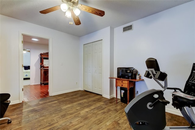 interior space featuring baseboards, visible vents, and wood finished floors