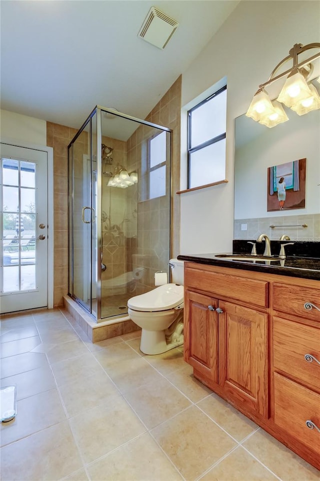 bathroom with a stall shower, tile patterned flooring, and visible vents