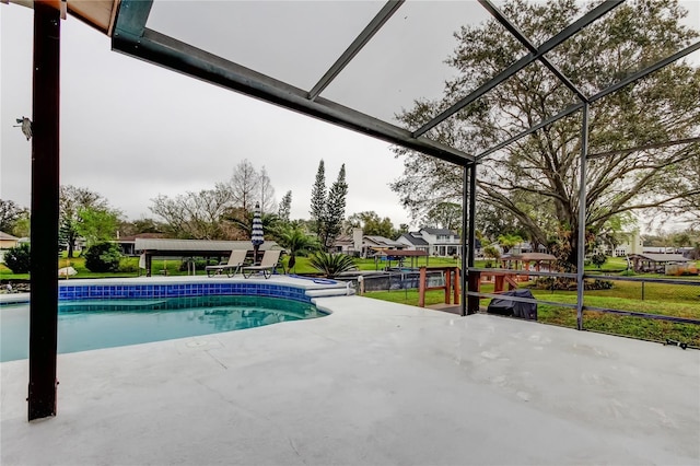 outdoor pool featuring a patio area and a lanai