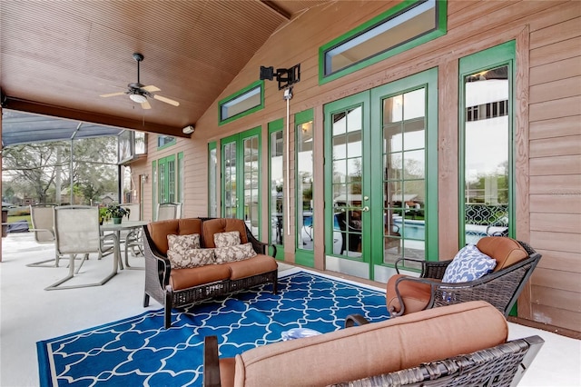 sunroom / solarium with a ceiling fan, vaulted ceiling, and a wealth of natural light