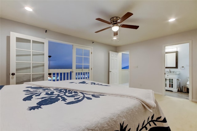 carpeted bedroom with a ceiling fan, recessed lighting, baseboards, and ensuite bath