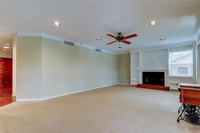 unfurnished living room featuring carpet, visible vents, baseboards, and ornamental molding