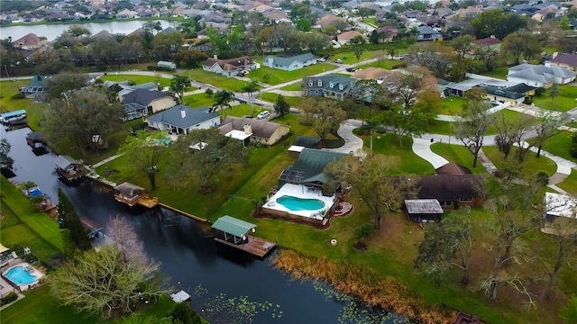 birds eye view of property with a residential view and a water view