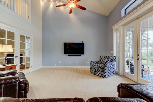 living room featuring baseboards, ceiling fan, carpet, french doors, and high vaulted ceiling