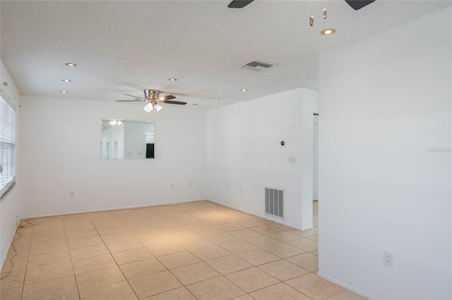 tiled empty room with ceiling fan