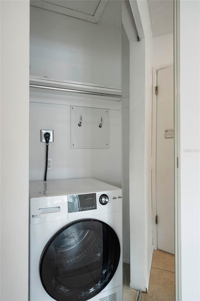 washroom featuring light tile patterned floors and washer / dryer