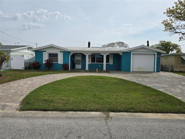 ranch-style home with a front lawn and a garage