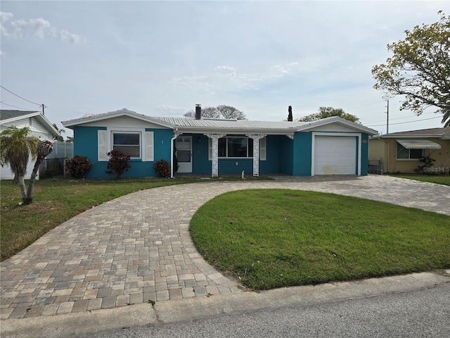 ranch-style home with a front yard and a garage