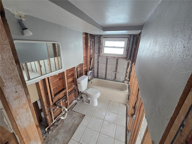 bathroom featuring tiled shower / bath combo, toilet, and tile patterned floors