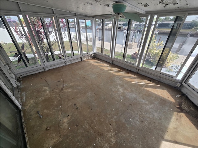 unfurnished sunroom with lofted ceiling and a water view