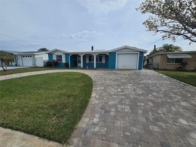 ranch-style home featuring a front lawn and a garage