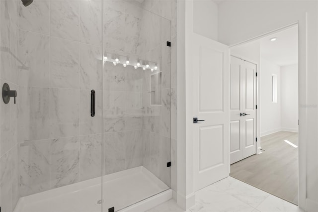 307 15th St N, Saint Petersburg, FL 33705 - full bath with a stall shower, marble finish floor, and baseboards