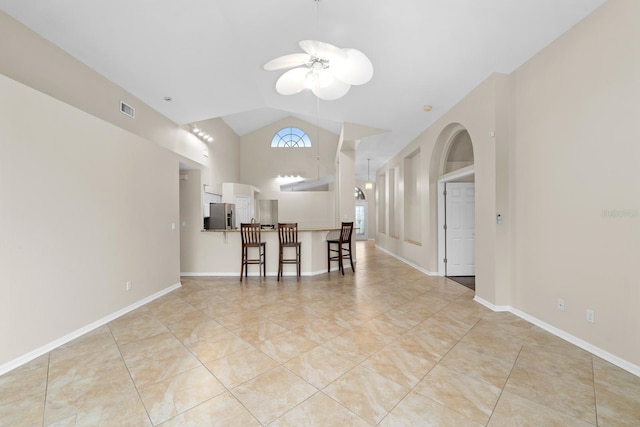 2015 Golf Manor Blvd, Valrico, FL 33596 - interior space with visible vents, light tile patterned floors, baseboards, ceiling fan, and vaulted ceiling