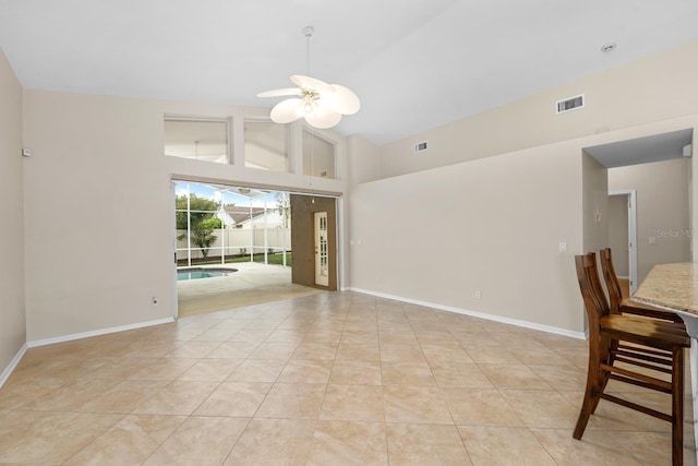 2015 Golf Manor Blvd, Valrico, FL 33596 - spare room with light tile patterned floors, a ceiling fan, baseboards, visible vents, and high vaulted ceiling
