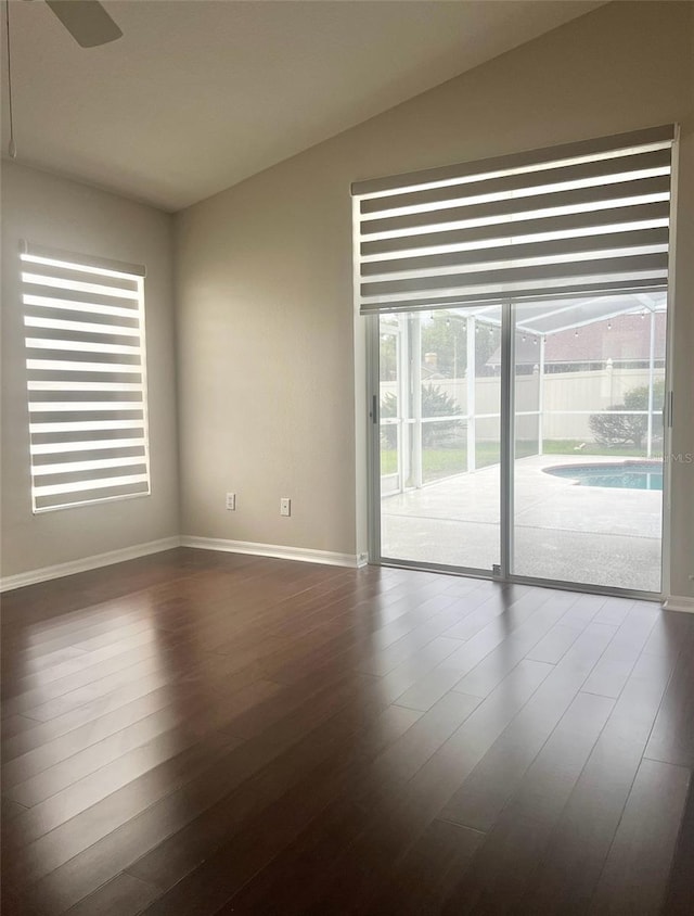 2015 Golf Manor Blvd, Valrico, FL 33596 - unfurnished room with ceiling fan, baseboards, lofted ceiling, and dark wood-style flooring