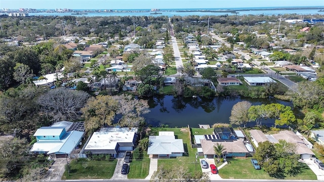 drone / aerial view featuring a residential view and a water view