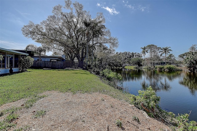 view of yard with a water view and fence