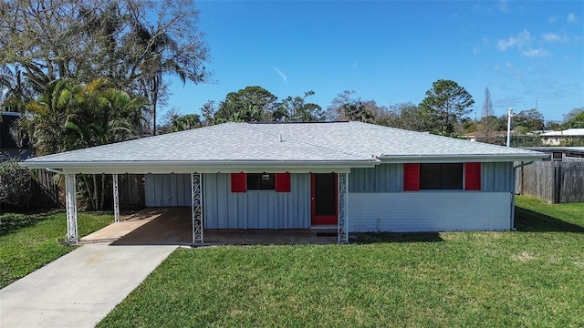 single story home featuring driveway, board and batten siding, a front yard, and roof with shingles