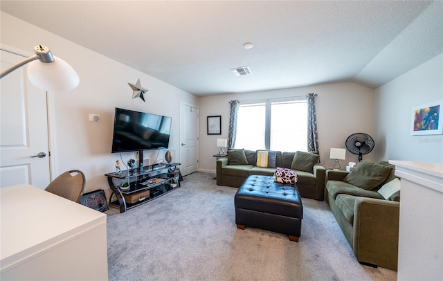 living area with light carpet, visible vents, vaulted ceiling, and a textured ceiling