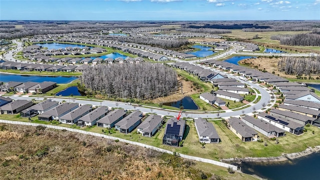 birds eye view of property with a water view and a residential view