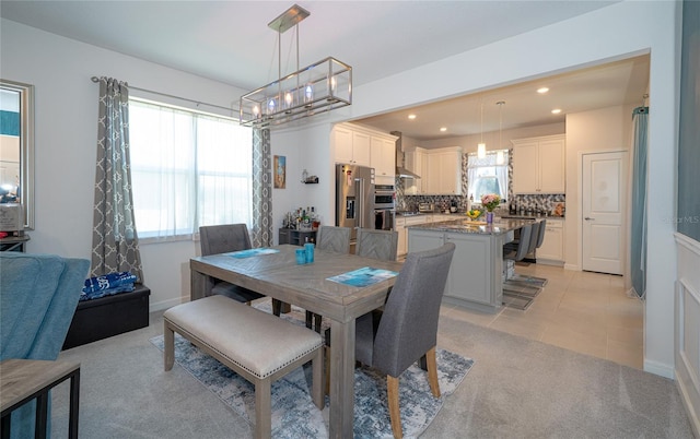 dining space featuring light colored carpet, recessed lighting, light tile patterned flooring, and baseboards