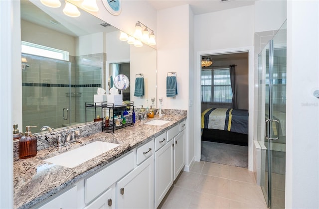 ensuite bathroom with tile patterned flooring, ensuite bath, visible vents, and a sink