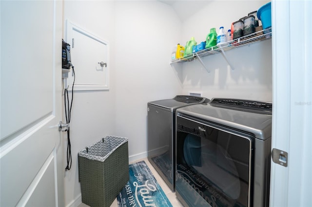 laundry room featuring laundry area, separate washer and dryer, and baseboards