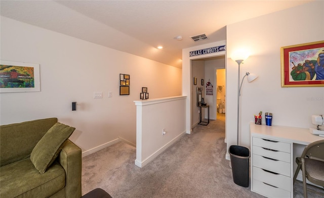 office area featuring light carpet, visible vents, and baseboards