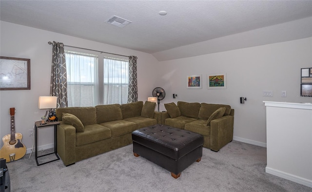 living area featuring baseboards, visible vents, light colored carpet, lofted ceiling, and a textured ceiling