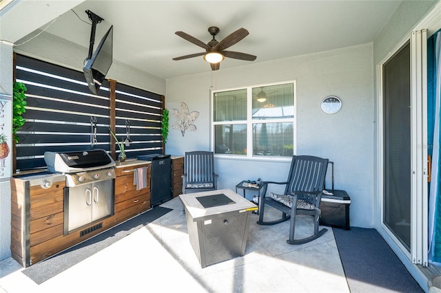 view of patio with visible vents, an outdoor fire pit, a grill, ceiling fan, and exterior kitchen