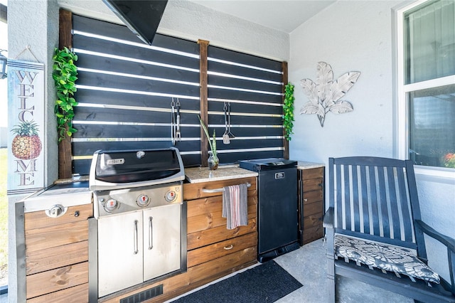 view of patio with a grill and visible vents