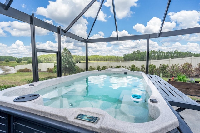 view of pool featuring a water view, a fenced backyard, and an outdoor hot tub