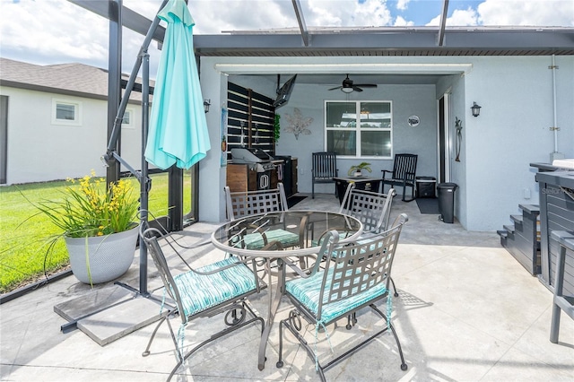 view of patio featuring a ceiling fan, outdoor dining space, and a grill