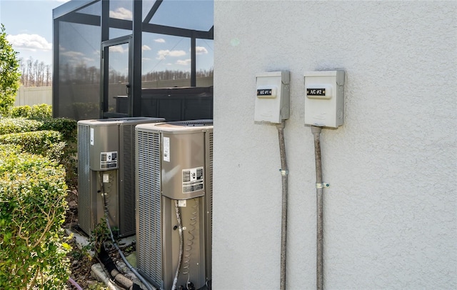 details featuring cooling unit and stucco siding