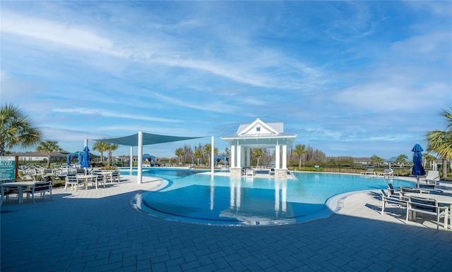 community pool with a patio area and a gazebo