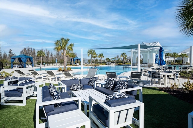 community pool with a lawn and a patio area