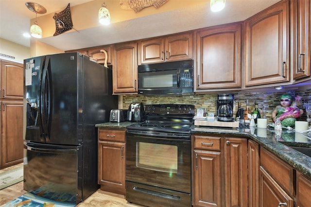 kitchen with hanging light fixtures, black appliances, tasteful backsplash, brown cabinetry, and dark stone countertops