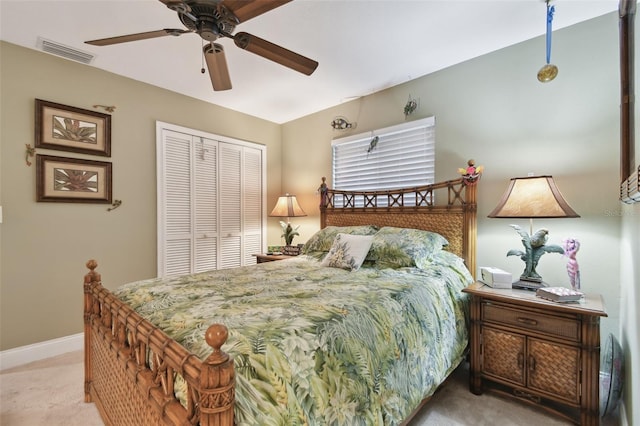 bedroom with light carpet, baseboards, visible vents, ceiling fan, and a closet