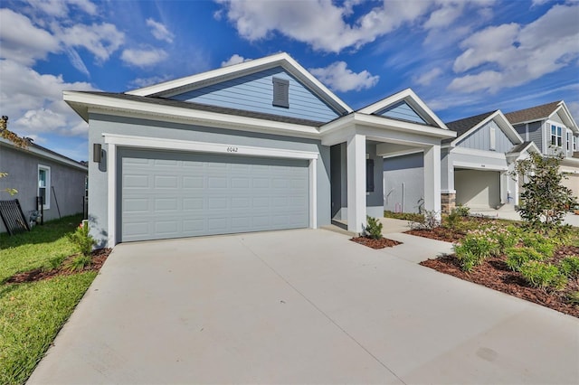 view of front of property featuring a garage, driveway, and stucco siding