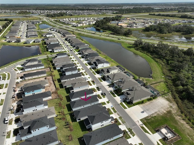 drone / aerial view with a water view and a residential view