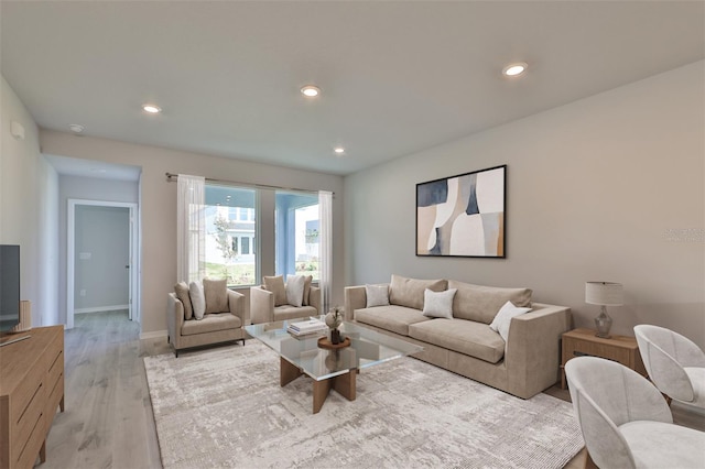 living area featuring baseboards, light wood-style flooring, and recessed lighting