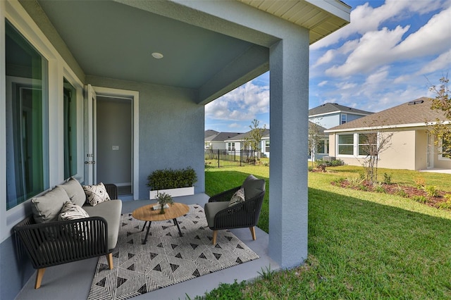 view of patio with a residential view, fence, and outdoor lounge area