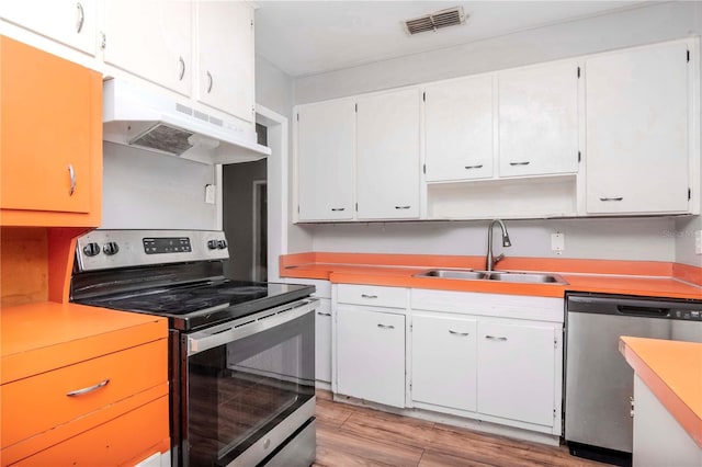 kitchen with white cabinetry, appliances with stainless steel finishes, and sink