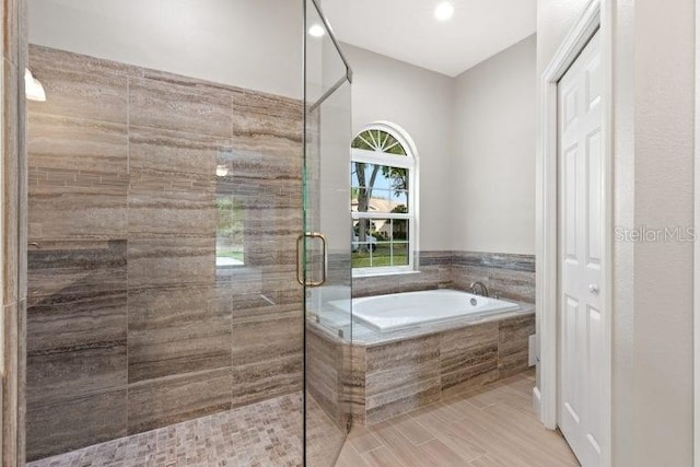 bathroom featuring plus walk in shower