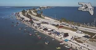 drone / aerial view featuring a water view and a beach view