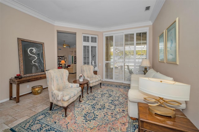 sitting room featuring visible vents, crown molding, baseboards, stone tile floors, and a ceiling fan