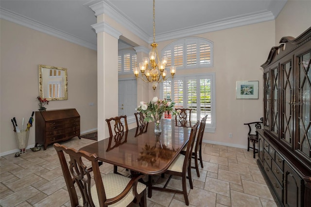 dining area featuring baseboards, decorative columns, stone finish flooring, crown molding, and a chandelier