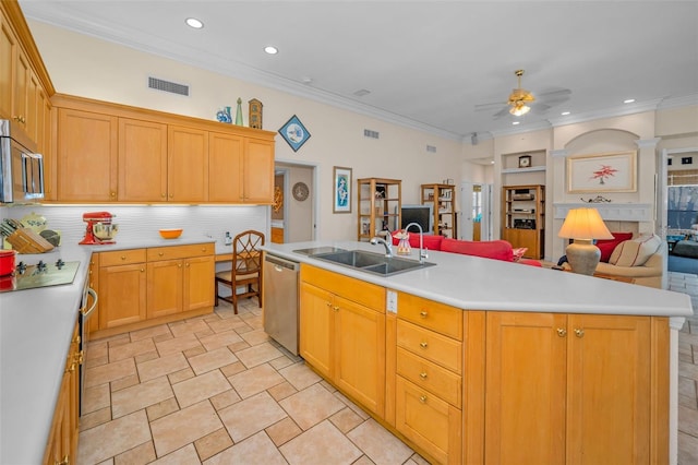 kitchen featuring a ceiling fan, a sink, light countertops, appliances with stainless steel finishes, and open floor plan